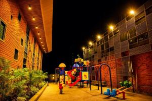 a playground with a slide in a building at night at The Weekend Address Managed By Stayzy in Dumas