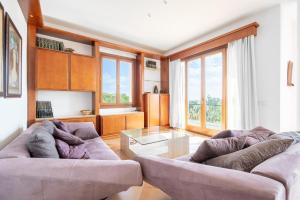 a living room with two couches and a glass table at Villas2meet Na Penyal 7 in Cala Millor