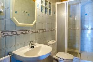a bathroom with a sink and a toilet and a shower at Can Consul in San Juan Bautista +19 photos