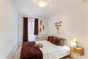 a bedroom with a bed with two shoes on it at Attaday Home Holidays in Ingenio
