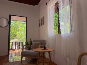 a room with a chair and a table and a window at Siam phangan in Ko Phangan