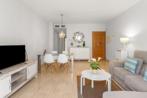 a living room with a couch and a tv at Beach Center Only 150 M Luxury in Fuengirola