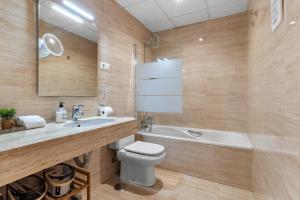 a bathroom with a sink and a toilet and a tub at Beach Center Only 150 M Luxury in Fuengirola +15 photos