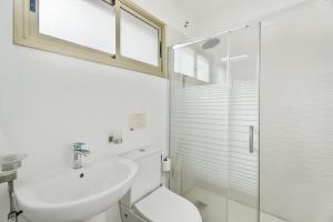 a white bathroom with a sink and a shower at Turandot 34 La Restinga in La Restinga +18 photos