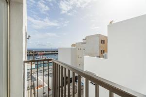 a balcony with a view of a harbor at Turandot 34 La Restinga in La Restinga