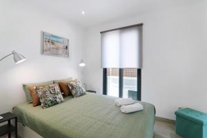 a bedroom with a large bed with a window at Casa Lopes in Fuzeta