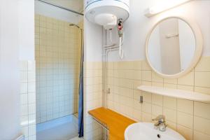 a bathroom with a sink and a shower at Les Mimosas - Appartement 08 in Cazaubon