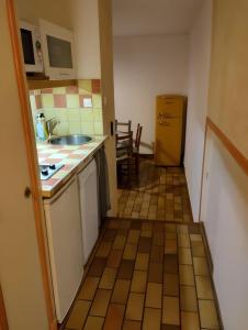 a small kitchen with a sink and a refrigerator at Gîte Capibay Les Herbes de Provence in Six-Fours-les-Plages +6 photos