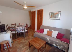 a living room with a couch and a table at Gîte Capibay Les Herbes de Provence in Six-Fours-les-Plages