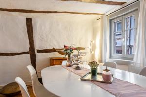 a dining room with a white table and chairs at Fachwerkhaus Für Dich in Eberbach