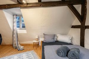a bedroom with a bed with blue sheets and pillows at Fachwerkhaus Für Dich in Eberbach