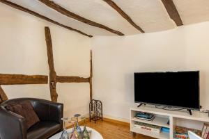 a living room with a flat screen tv on a wall at Fachwerkhaus Für Dich in Eberbach