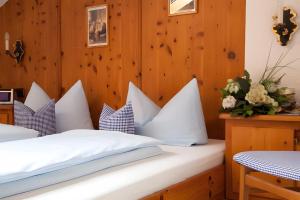 a bedroom with two beds with white pillows at Landhaus Reiser in Grainau