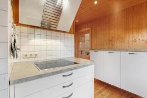 a kitchen with white cabinets and a sink at Frenkhausener Ruhepol in Meschede
