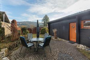 a patio with a table and chairs in a backyard at Frenkhausener Ruhepol in Meschede