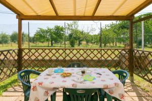 a table with a plate of food on a patio at Il Pino - monolocale Lavanda in Cecina