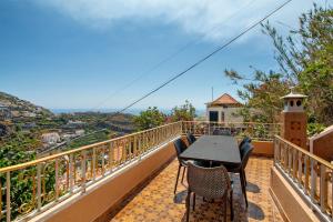 a balcony with a table and chairs and a view at Pico The Best View in Ribeira Brava