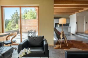 a living room with a couch and a chair at Haus Lichtenstern in Soprabolzano +23 photos