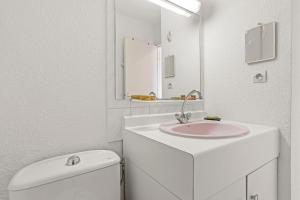 a white bathroom with a sink and a toilet at Appartement à deux pas de la mer in Fréjus +12 photos