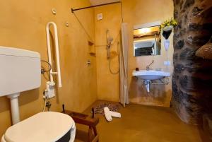 a bathroom with a toilet and a sink at Dammuso Civulia Pantelleria in Pantelleria +37 photos