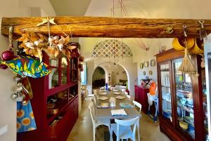 a dining room with a table and chairs at Dammuso Civulia Pantelleria in Pantelleria