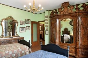 a bedroom with a large wooden bed and a large mirror at Appartamento Iris in Cisterna dʼAsti