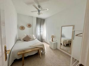 a white bedroom with a bed and a mirror at Casa Alba in Lomo de Arico