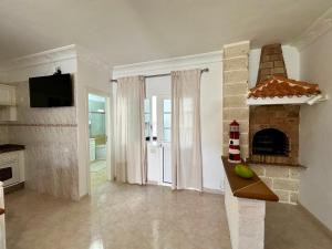 a living room with a fireplace and a tv at Casa Alba in Lomo de Arico