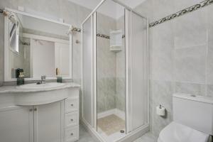 a white bathroom with a shower and a sink at Casa Alba in Lomo de Arico +26 photos
