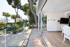 a living room with glass doors and a view of a patio at Ethel in Castelldefels