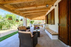 an outdoor patio with a wooden pergola at Foxi lioni in Tertenìa