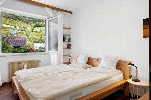 a bedroom with a bed and a large window at Haus Marlene in Cornedo all'Isarco