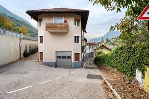 a building with a garage on the side of a road at Haus Marlene in Cornedo all'Isarco
