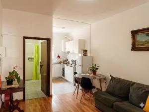 a living room with a couch and a table at apartment near the airport in Ponta Delgada