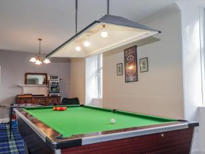 a living room with a pool table in it at Achnagonlin House in Grantown on Spey