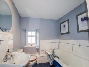 a bathroom with a sink and a tub and a toilet at Achnagonlin House in Grantown on Spey +52 photos