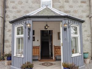 a small grey shed in front of a house at Achnagonlin House in Grantown on Spey