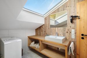 a bathroom with a sink and a skylight at New - Steinhof Val di Mezzo in Val di Mezzo +59 photos