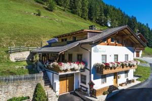 a house with flower boxes on the side of it at New - Steinhof Val di Mezzo in Val di Mezzo