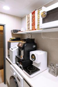 a kitchen with a coffee maker on a counter at D-Haus Hostel Dongdaemun in Seoul