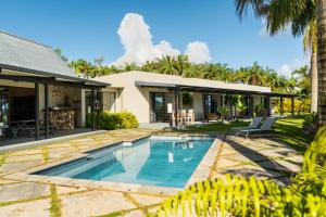 an exterior view of a house with a swimming pool at Villa Kamaya, Chamarel in Chamarel