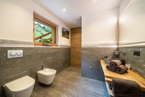 a bathroom with a toilet and a sink at Bergsteiger Apartment - Patleidhof in Naturno +29 photos