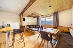a living room with a couch and a table at Bergsteiger Apartment - Patleidhof in Naturno