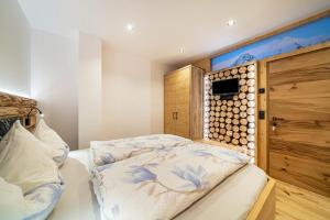 a bedroom with a bed and a wooden wall at Bergsteiger Apartment - Patleidhof in Naturno