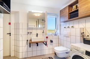 a bathroom with a sink and a toilet at Ferienwohnung Romanas in Ostrach +19 photos