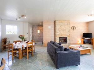 a living room with a couch and a table and a fireplace at Gîte Pors Mabo in Trébeurden