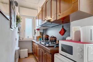 a kitchen with a stove and a microwave at Casa Lago Vicky in Omegna +29 photos