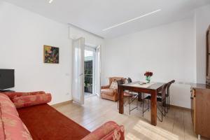 a living room with a table and a dining room at Casa Lago Vicky in Omegna