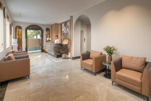 a lobby with two chairs and a counter in a building at Lam Anh Hotel 10 Ngoai Giao Doan in Hanoi