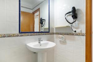 a bathroom with a sink and a mirror at Casa Paqui Bustos 1 in Conil de la Frontera +17 photos